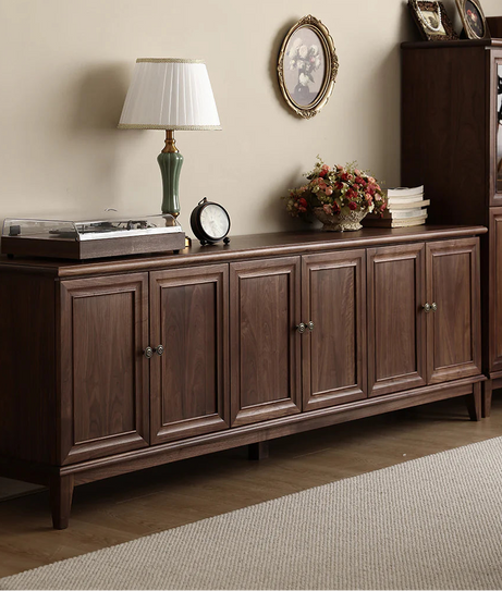 Wooden sideboard with decorative items in a room setting