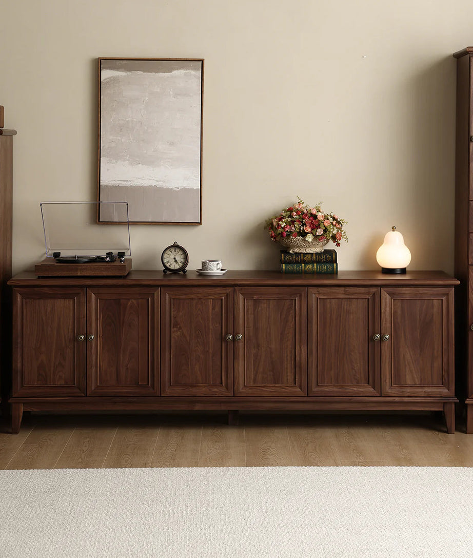 Wooden sideboard with decorative items in a room setting