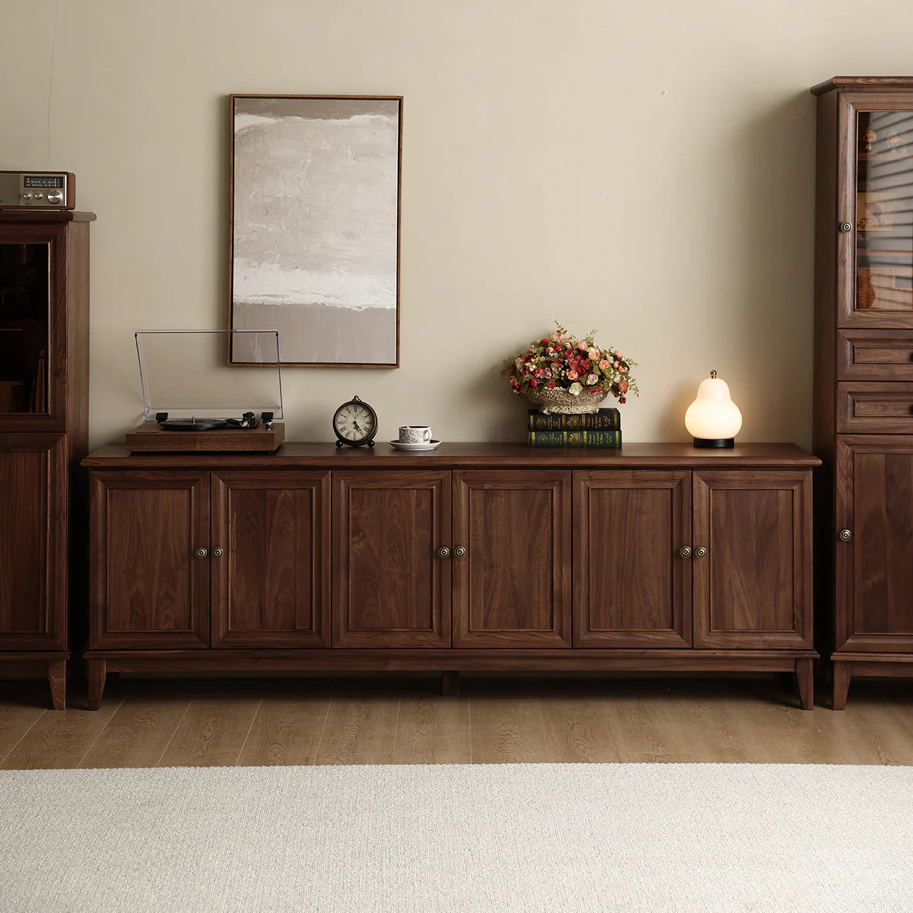 Wooden sideboard with decorative items in a room setting